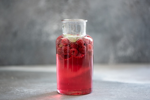 Homemade strawberry and blueberry lemonade with ice and mint