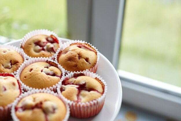 Homemade strawberry muffins on plate