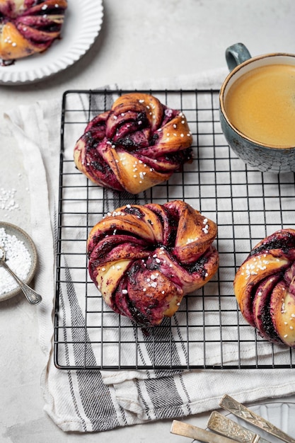 Homemade sweet yeast twisted buns with blueberries