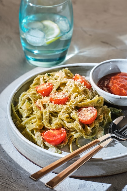 Homemade Tagliatelle pasta with zucchini, tomatoes and cod