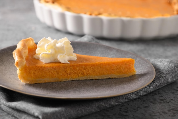 Homemade tasty Pumpkin Pie with autumn decorations and leaves for Thanksgiving Day