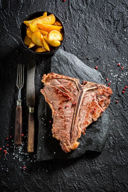 Homemade tbone steak and chips on the black rock