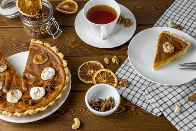 Homemade Thanksgiving Pumpkin Pie with whipped cream and latte Clean eating dieting vegan food concept top view