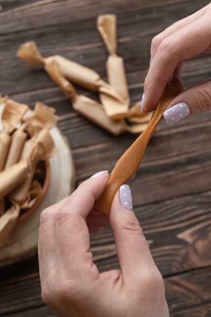 Homemade toffee candy in a female hand.