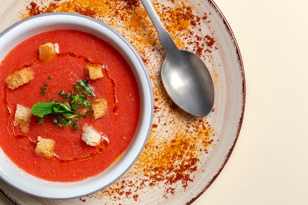 Homemade tomato soup with bread, mint and olive oil