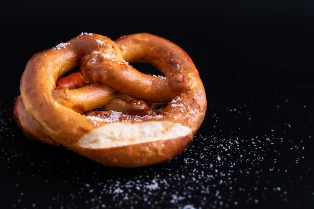 Homemade twisted knot Soft salt Pretzels on black slate board background 