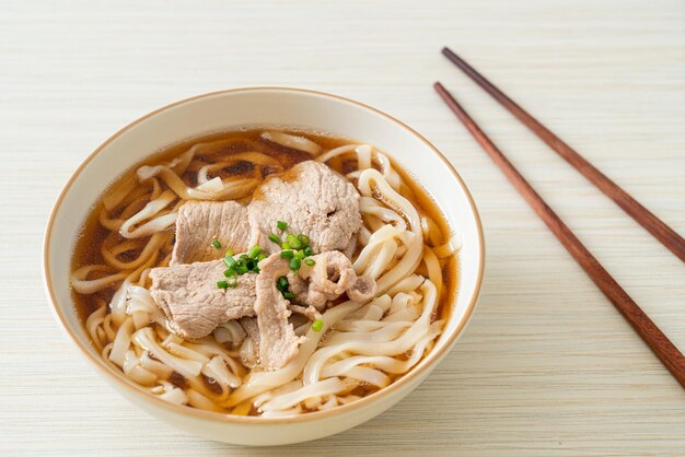 Homemade udon noodles with pork in soy or shoyu soup