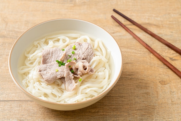 homemade udon ramen noodles with pork in clear soup