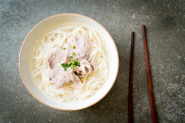 homemade udon ramen noodles with pork in clear soup