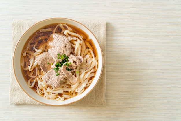 homemade udon ramen noodles with pork in soy or shoyu soup