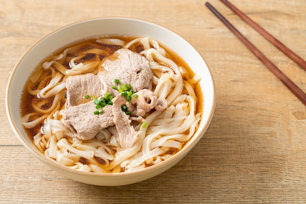 homemade udon ramen noodles with pork in soy or shoyu soup