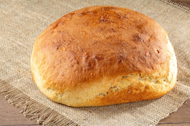 Homemade Ukrainian bread made from white wheat flour on a burlap napkin