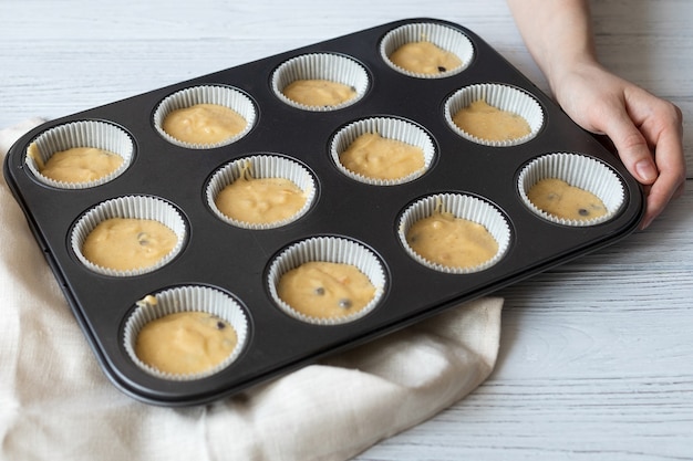 Homemade uncooked muffins, homemade baked goods in the form on the table