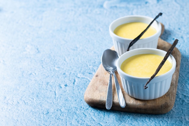 Homemade vanilla custard on blue background