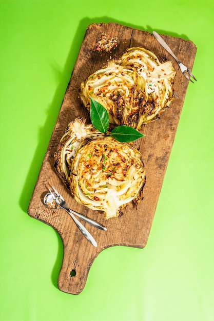 Homemade vegan cabbage steaks with herbs and spices Healthy food ready to eat on a cutting board