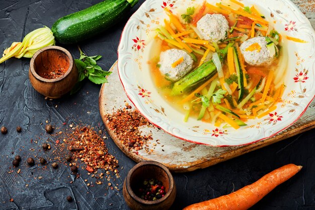 Homemade vegetable soup with meatballs and vegetables.Soup with zucchini.