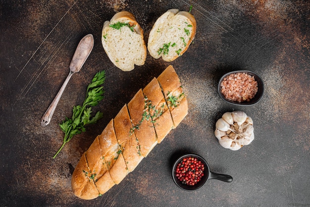 Homemade vegetarian sandwich cream cheese butter garlic bread set, on old dark rustic table background, top view flat lay