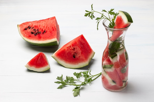 Homemade vitamin watermelon water with greens in glass jar