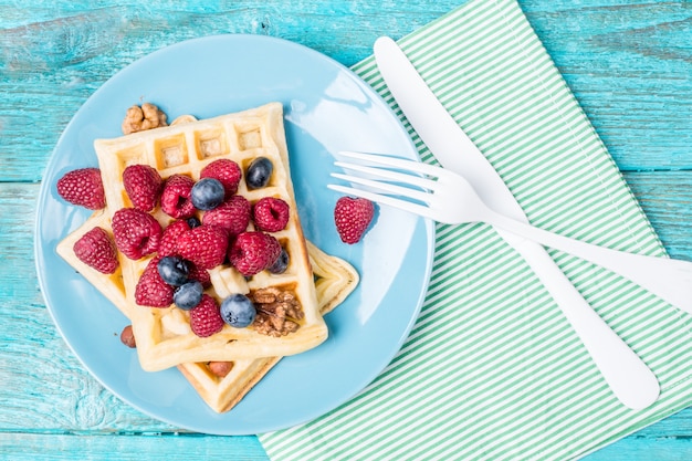 Homemade waffles with raspberries and blueberry