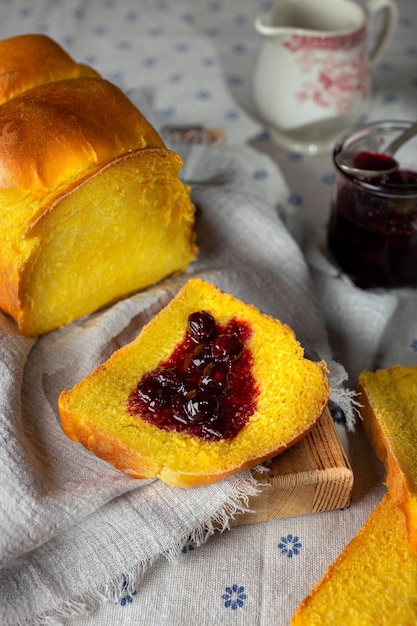 Homemade yeast wheat carrot bread with butter and jam