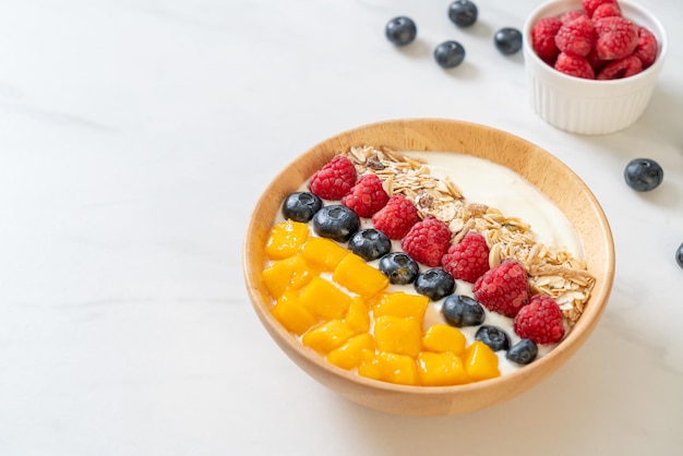 Homemade yogurt bowl with raspberry blueberry mango and granola