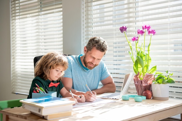 Homeschooling and selfeducation back to school busy father and son painting at home