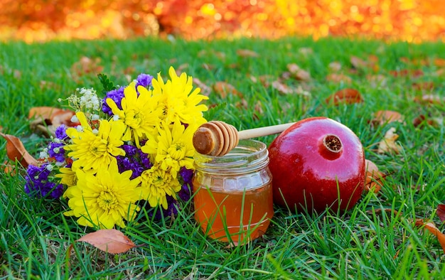 Honey apple and pomegranate wooden table over bokeh background