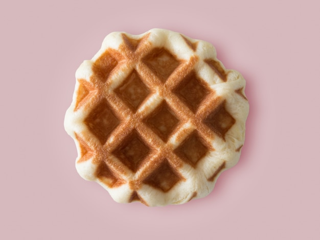 Honey brown waffle on colour background.