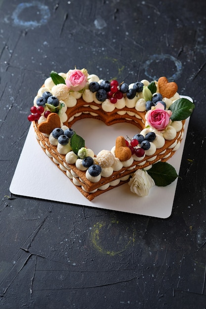 Honey cake with fresh blueberries herbs and cream cheese cream Heart cake