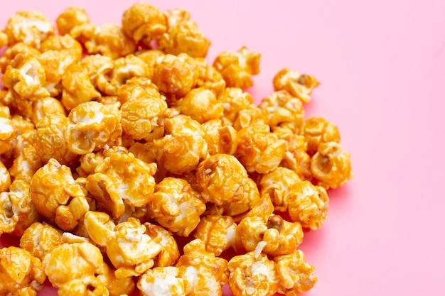 Honey caramel popcorn on pink background