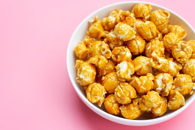 Honey caramel popcorn on pink background