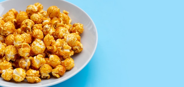 Honey caramel popcorn on white background