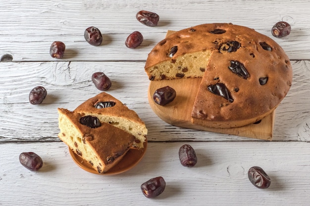 Honey and date cake on a white wooden surface