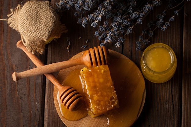 Honey dipper and honeycomb. nuts and apples with honey and nuts of various kinds