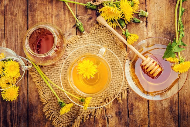 Honey from dandelion and a Cup of tea. Selective focus.