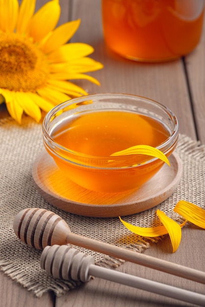 Honey in a glass jar on a wooden table