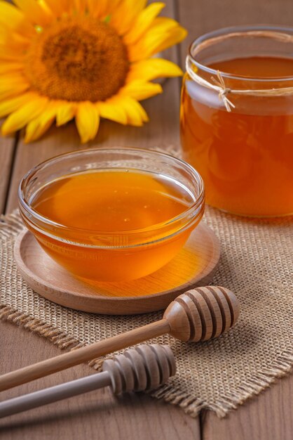 Honey in a glass jar on a wooden table