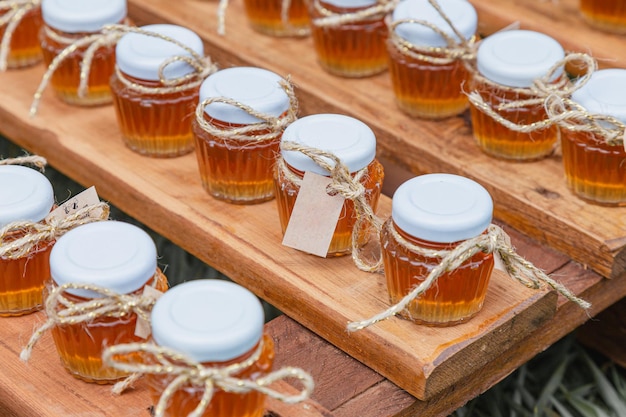 Photo honey glass jars wedding souvenirs and sweets bottled honey bees stock