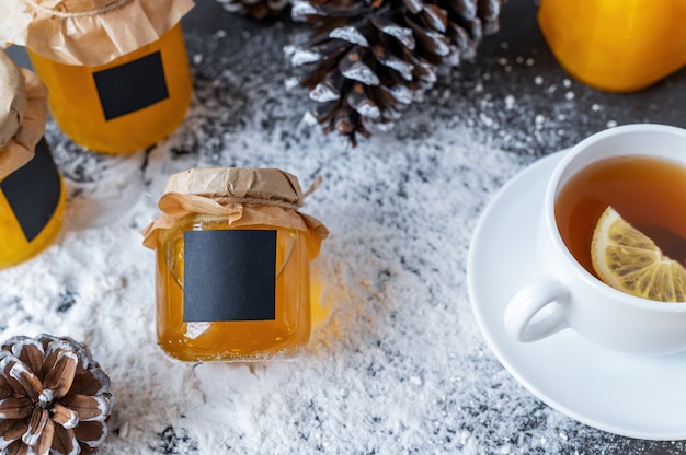 Honey products composition. Honey in jars, tea and fir cones.