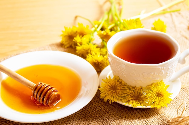 Honey with dandelions cup of tea with dandelion selective focus