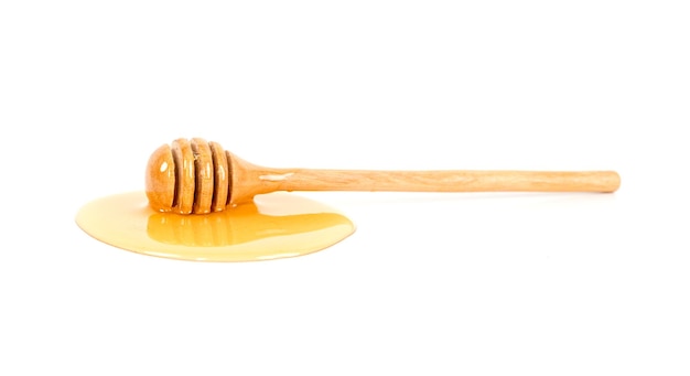 Honey with honey dipper on white background