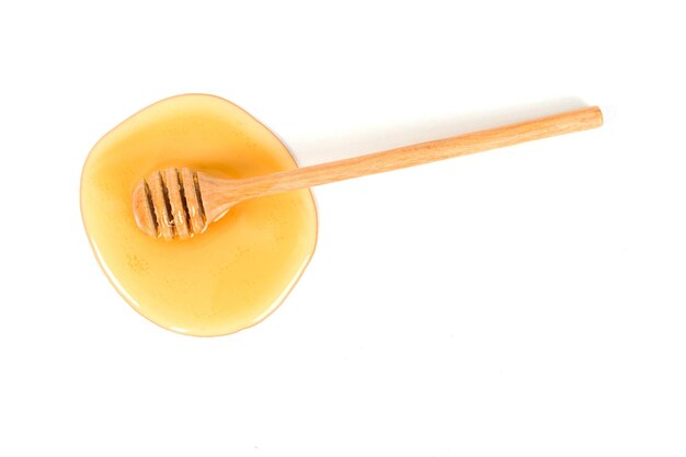 Honey with honey dipper on white background