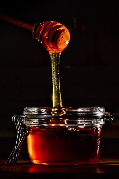 Honey with a natural wooden stick