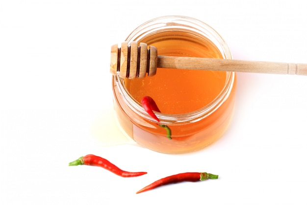 Honey with red hot pepper isolated 