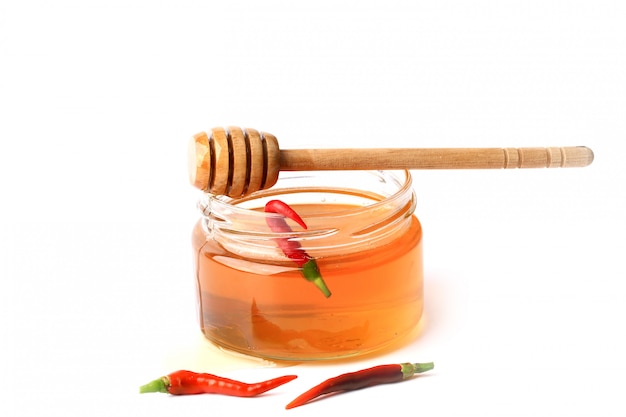 Honey with red hot pepper isolated 