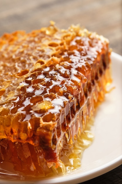 Honeycomb close-up. Fresh honey from the field on an old wooden table.