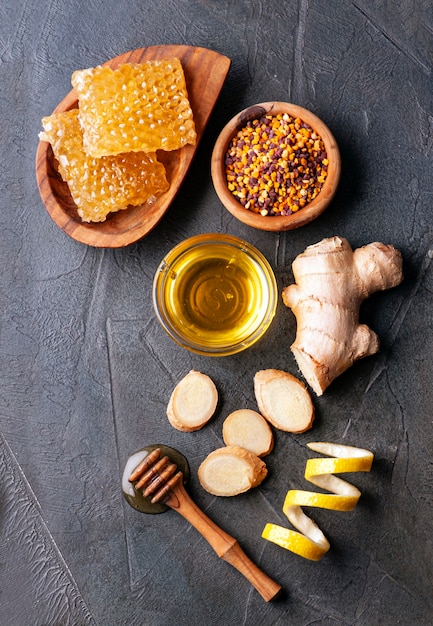 Honeycomb with ginger root and pollen flower closeup. Healthy food ingredient.