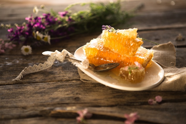 Honeycomb and wooden honey dipper.