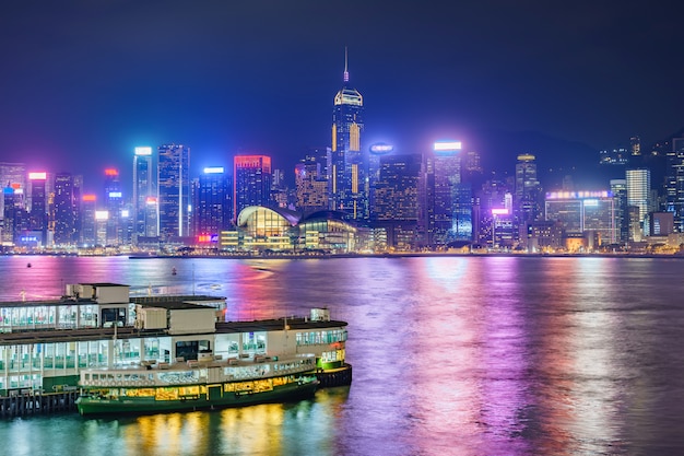 Hong Kong skyline cityscape downtown skyscrapers over Victoria Harbour in the evening. Hong Kong, China