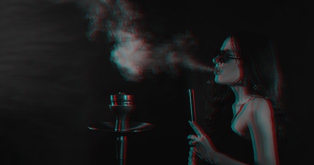 Hookah atmosphere The girl enjoys smoking a hookah sheesha Place for your text Photo in the glitch effect